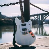 photo of guitar near river