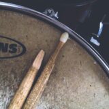 two brown drum sticks on brown snare stick