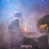 performing drummer surrounded by fogs