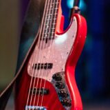 bass guitar with knobs and strap on stage