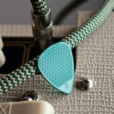 green chord and green plectrum in close up photography